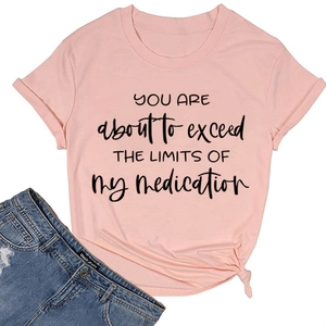 Detail of pink cotton t-shirt with slogan and distressed denim shorts casual outfit