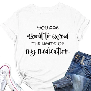 Detail of white cotton T-shirt featuring black printed quote and folded sleeve cuff
