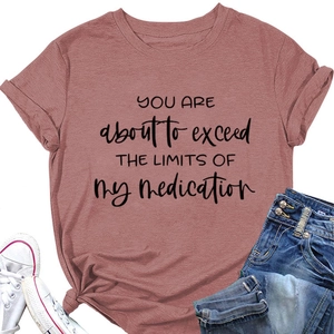 Detail of round neck t-shirt with humorous quote and knot hem in dusty rose color
