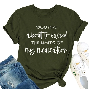 Close-up of olive green t-shirt with slogan print and casual knotted hem detail