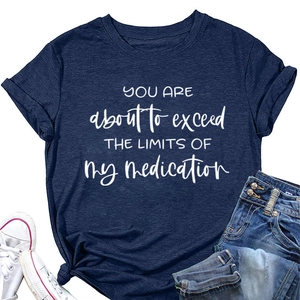 Flat lay view of navy t-shirt with You Are About To Exceed print and casual outfit