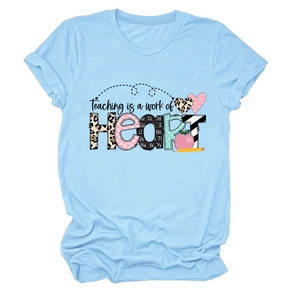Detail of light blue t-shirt with Teaching is a work of Heart colorful graphic print
