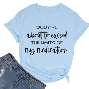 Detail of light blue cotton T-shirt with black slogan and rolled sleeve design