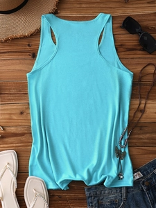 Flat lay of cyan racerback tank top with summer accessories on wooden background