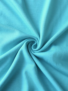 Macro shot of bright blue knitted fabric texture showing soft elastic ribbed material