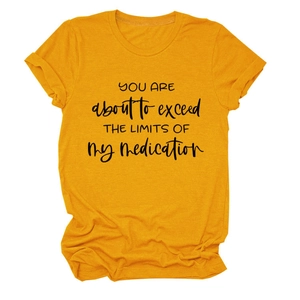 Detail of yellow cotton t-shirt with YOU ARE ABOUT TO EXCEED text print in black