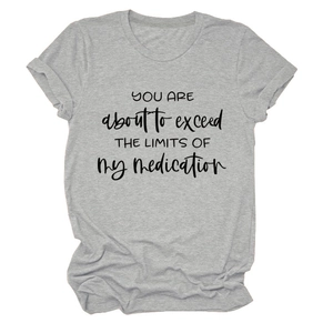 Close-up of grey crew neck T-shirt featuring humorous black text slogan on cotton fabric