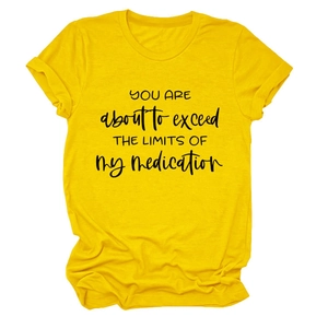 Detail of yellow cotton t-shirt with YOU ARE ABOUT TO EXCEED printed slogan and rolled sleeves
