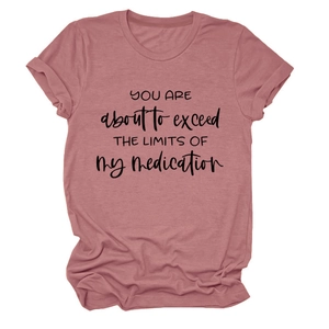 Detail of rolled sleeves and printed slogan on pink cotton t-shirt for women