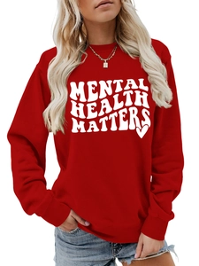 Detail of red crewneck sweatshirt featuring white Mental Health Matters slogan print