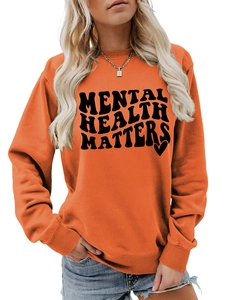 Detail of orange crewneck sweatshirt with Mental Health Matters print and ribbed neckline