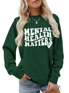 Close-up of Mental Health Matters slogan print on forest green crewneck sweatshirt