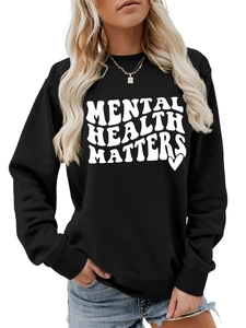 Close-up of Mental Health Matters wavy text print on a black crewneck sweatshirt