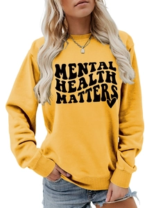 Detail of Mental Health Matters yellow sweatshirt showing ribbing and print
