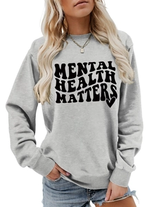 Detail of Mental Health Matters text print on a light gray crewneck sweatshirt