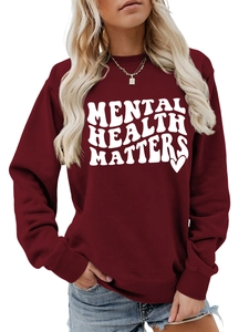 Detail of burgundy crewneck sweatshirt with white Mental Health Matters printed text