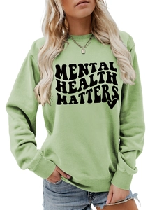 Detail of Mental Health Matters slogan on a light green crewneck sweatshirt with heart icon