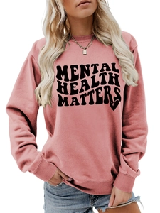 Detail of pink crewneck sweatshirt featuring black Mental Health Matters wavy text print