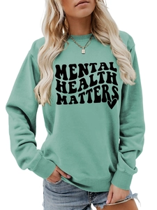 Close-up of Mental Health Matters slogan and heart print on mint green sweatshirt