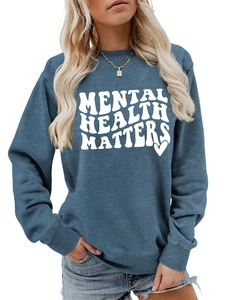 Blue-grey sweatshirt detail showing the Mental Health Matters white print and crewneck cut