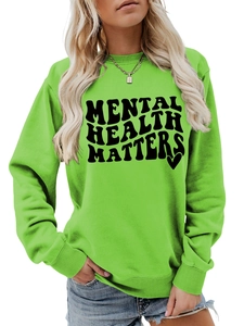 Detail of ribbed crew neck and black Mental Health Matters print on green sweatshirt