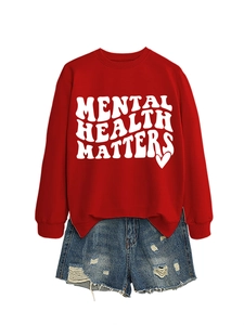 Detail of red mental health matters sweatshirt with wavy white text and denim shorts
