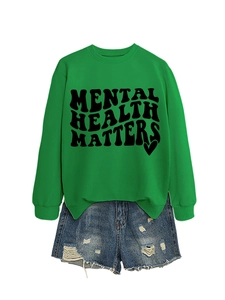 Mental Health Matters bright green sweatshirt paired with ripped denim shorts