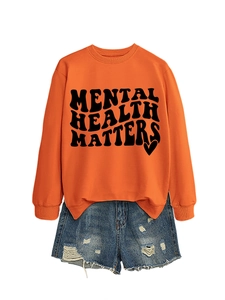 Detail of Mental Health Matters text and heart print on bright orange sweatshirt
