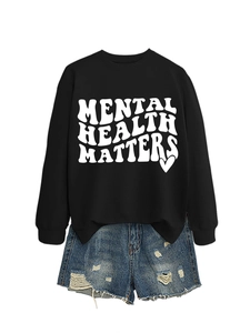 Close-up of Mental Health Matters slogan print on black long sleeve crewneck sweatshirt
