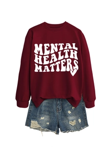 Detail of burgundy Mental Health Matters sweatshirt with denim shorts on white background