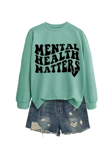 Close-up of Mental Health Matters text printed on mint green long sleeve sweatshirt