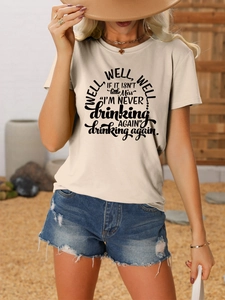 Detail of Well Well Well short sleeve tee in beige cotton paired with denim shorts