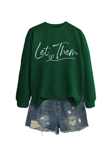Close-up of green Let Them sweatshirt paired with distressed denim shorts on white background