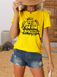 Detail of yellow cotton t-shirt with black graphic text paired with denim shorts