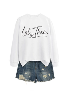 Detail of Let Them print on white sweatshirt paired with distressed denim shorts
