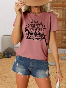 Detail of vintage pink t-shirt featuring funny black quote print with denim shorts