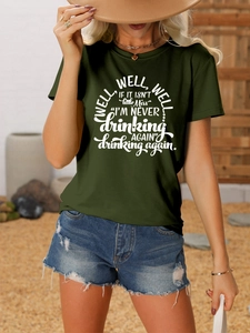 Detail of olive green t-shirt with well well well text and denim shorts outfit