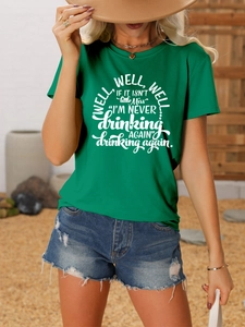 Close-up of artistic white Well Well Well letter print on green crew neck cotton t-shirt