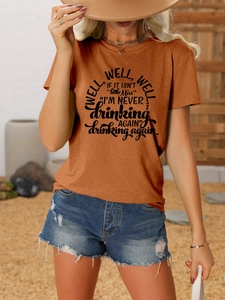 Detail of burnt orange crew neck T-shirt featuring Well Well Well artistic typography