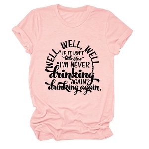 Close-up of pink crew neck T-shirt featuring bold black Well well well typography