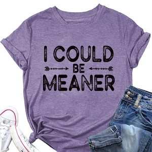 Détail du t-shirt en coton violet avec texte 'I COULD BE MEANER' et nœud frontal tendance