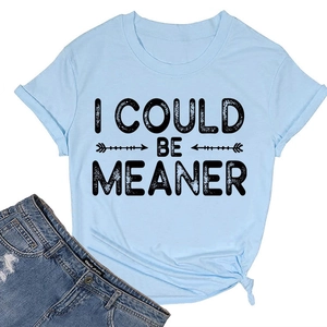 Détail du t-shirt en coton bleu clair avec texte 'I COULD BE MEANER' et nœud sur l'ourlet