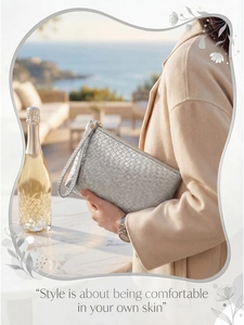 Silver woven texture clutch bag with gold zipper and wrist strap in seaside setting