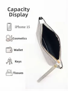Silver woven envelope clutch showing interior capacity for phone and essentials