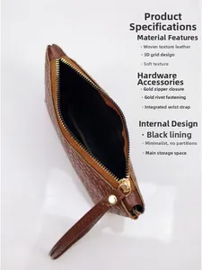 Detail of oversized brown woven clutch showing smooth gold zipper and soft wrist strap