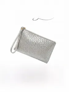 Detail of silver woven clutch bag featuring metallic texture, wrist strap, and top zipper