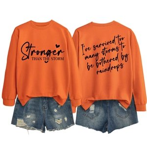 Detailed front and back view of orange Stronger Than The Storm crewneck sweatshirt