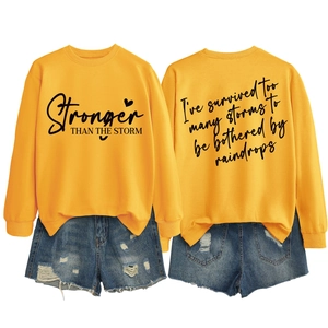 Front and back detail of yellow long sleeve sweatshirt with Stronger than the Storm print