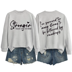 Detailed front and back view of grey sweatshirt with Stronger Than The Storm text print