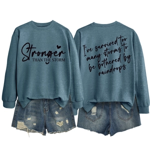 Front and back detail of blue sweatshirt with Stronger Than The Storm text and denim shorts